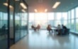 © ming - Office background. Blurred empty open space office with windows. Abstract bokeh on the background of an office interior for design. High quality