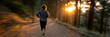 © gunzexx png and bg - A dynamic shot of a jogger running along a forested path as the sun sets, capturing the essence of health, vitality, and the joy of outdoor exercise.
