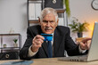 © Andrii Iemelianenko - Caucasian angry mad stressed senior businessman try to pay online shopping with smartphone blocked credit card. Annoyed grandpa buying, bank refuse problem unsuccessful payment lack of money balance.