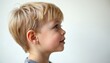 © miss irine - Cute little boy profile on light studio background. Kid looks forward with dreamy expression. Fair-haired child shows innocence. Concept of children healthy lifestyle, happy childhood medical catalog.