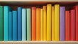 © miss irine - Colorful book spines arranged in gradient on wooden shelf. Books display rainbow colors creating neat ordered pattern. Visual for reading education knowledge and creativity.