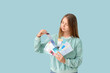 © Pixel-Shot - Young woman with color samples on light blue background
