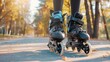 © ds17 - Close-up of black roller skates on a paved path surrounded by autumn trees and fallen leaves. The scene captures the essence of outdoor skating in fall.