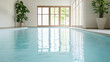 © siraphol - Peaceful indoor pool with sunlight streaming through large windows, calm water reflection