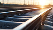 © A2Z AI  - Converging rail tracks stretch into the horizon, illuminated by the warm glow of the setting sun. The close-up perspective emphasizes the parallel rails and the gravel ballast.