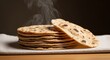 © photoplotnikov - Freshly baked stack of warm whole wheat roti with steam rising