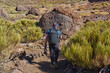 © Xalanx - Hiker with backpack on a trail towards Pico Viejo among giant lava bombs