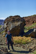 © Xalanx - Hiker with backpack on a trail towards Pico Viejo among giant lava bombs