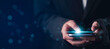 © The KonG - Social application usage concept showing businessman using smartphone with glowing screen effect. Represents scrolling, tapping, and digital interaction with mobile app interface in real-time.