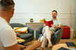 © Cristian Blázquez - Men reading books relaxing in modern lounge area