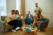 © Cristian Blázquez - Friends enjoying book club discussion in living room