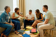 © Cristian Blázquez - Diverse adults discussing ideas during group therapy session