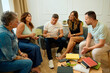 © Cristian Blázquez - Diverse adults engaged in group therapy discussion