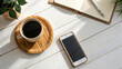 © Uncle-Ice - A comforting cup of coffee steaming, notebook and smart phone on a worn wooden table