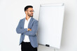 © luismolinero - Young caucasian man isolated on white background giving a presentation on white board and making doubts gesture