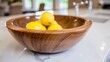 © Konstiantyn Zapylaie - Wooden bowl with fresh lemons on marble kitchen countertop