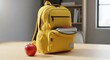 © Bilal Ulker - Backpack and Apple: A vibrant yellow backpack stands ready for learning, accompanied by a fresh red apple, symbolizing education and a healthy start to the day.