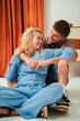 © Jose Calsina - A happy couple engaging in playful interaction, sharing smiles and laughter as they enjoy a heartfelt moment together, radiating joy and connection in their warm relationship at home.
