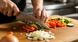 © Sabrina - Culinary Creation: A pair of hands expertly slice fresh vegetables on a wooden cutting board, capturing a moment of focused food preparation