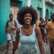 © Imagine  - Joyful young woman laughing in a vibrant urban street, surrounded by colorful buildings and people, radiating happiness, freedom, and youthful energy on a sunny day in the city.