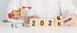 © Jo Panuwat D - Happy New Year 2026 with shopping cart. online shopping, Marketplace platform website, technology, ecommerce, shipping delivery, logistics and online payment