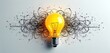 © Maryna - Yellow light bulb with black scribbles around. Glowing lamp with messy lines on white background. Idea concept with bright shining light bulb and chaotic strokes.