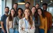© Joseph - Group of business multiethnic people men and women looking cheerful at camera and smiling indoors. Company employees or group of staff standing in office confidently. Team work concept. Banner.