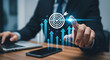 © umi - Targeted Goals Achieved: A focused professional in a modern office environment, envisions and strategizes the attainment of goals with a touch on a digital interface and visualized targets.