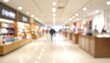 © lapui - Blurred shopping mall interior with lights and people.