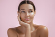 © Buyanskyy Production - Serene Woman Resting Face On Hand Against Pink Background In Beauty Portrait