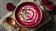 © fivan - A top view, vibrant beetroot soup with white cream swirl, copy space