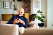 © gzorgz - Happy middle-aged man with smartphone relaxing at home and drinking tea