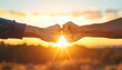 © generAte Ideas - Fist bump teamwork connection unity support partnership success sunrise friendship motivation Two hands meet fist bump sunrise, symbol of unity, teamwork, support, and shared success with warm