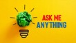 © Muji Creatives - Crumpled green paper light bulb with “Ask me Anything” text on bright yellow background.