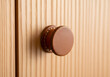 © Arif - Simple round leather handle on light wood surface texture