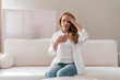 © brizmaker - Mature woman experiences severe chest pain and difficulty breathing at home