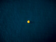 © AmazingAerialAgency - Aerial view of a vibrant yellow object contrasts against the deep blue sea, creating a striking visual focal point, Ksamil, Vlore County, Albania.