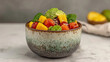 © Sonya - A bowl filled with fruit and vegetables on top of a table