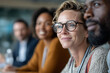 © lashkhidzetim - A woman with glasses is smiling at a group of people