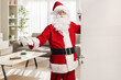 © Ljupco Smokovski - Santa Claus opening a door and gesturing welcome