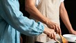© Anna - Couple cooking together in a home kitchen. Close-up of hands preparing a healthy meal in a pan. Domestic lifestyle and partnership concept