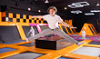 © JackF - Dynamic teenage boy wearing sport clothes high jumping in trampoline arena