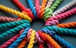 © Helen - Colorful ropes intertwined in circle showing unity, teamwork. Diverse ropes connected represent business metaphor for partnership synergy. Image collective effort to achieve common goal with strong