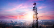 © paul - Telecommunication tower with cityscape background at sunset,panoramic view