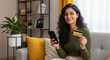 © PRASANNAPIX - Happy Indian woman shopping online with credit card and phone