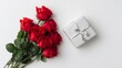 © Nayyab - Red, white, and pink roses surrounding a small pink gift box with red ribbon on white background for valentine's day celebration and romantic love concept