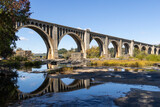 Concrete arched bridge reflected in the James River