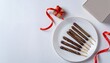 © Line - Pepero snack sticks arranged on plate with red ribbon and card