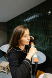 Woman styling hair in pajamas for beauty routine