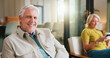 © BuyOutFelix05/peopleimages.com - Break, portrait and smile of old man on sofa in living room of home with wife for retirement. Relax, weekend and wellness with happy senior people in apartment together for chilling or free time